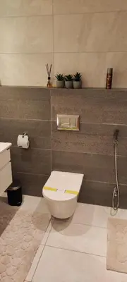 a bathroom with a toilet and a sink at Amazing Studio in DAMAC in Amman