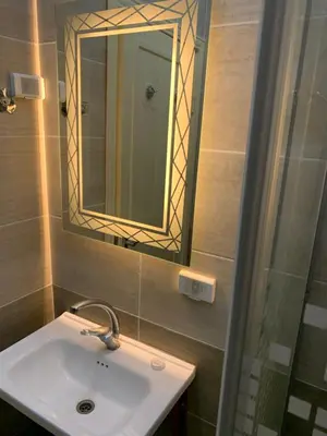 a bathroom with a sink and a mirror at Asad Apt. in Wadi Musa