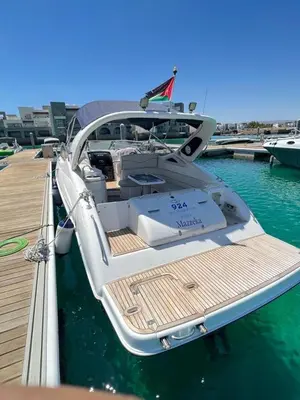 a white boat parked at a dock in the water at Roza Beach Aqaba in Aqaba