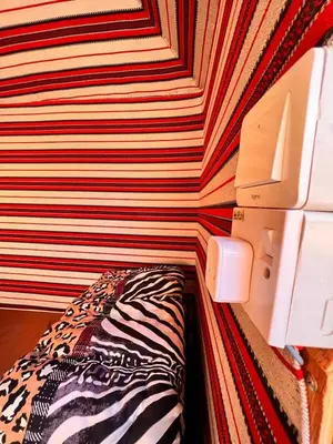 a corner of a room with a striped wall at Wadi Rum White Mountain Camp in Wadi Rum