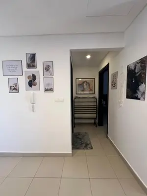 a hallway with pictures on the walls of a room at Spacious apartments with Sea view at Samarah Resort in Sowayma