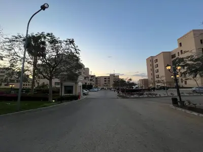 an empty street in a city with buildings at Spacious apartments with Sea view at Samarah Resort in Sowayma