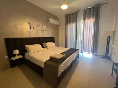 a bedroom with a large bed and a large window at Spacious apartments with Sea view at Samarah Resort in Sowayma
