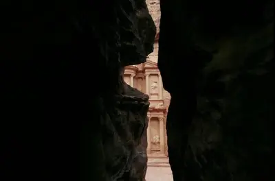 a view of a building from inside a cave at petra agora hotel in Wadi Musa