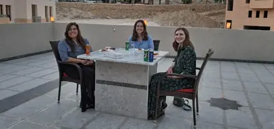 three women sitting at a table on a patio at petra agora hotel in Wadi Musa