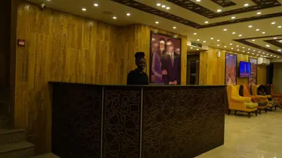 a lobby with a picture of a man on the wall at petra agora hotel in Wadi Musa