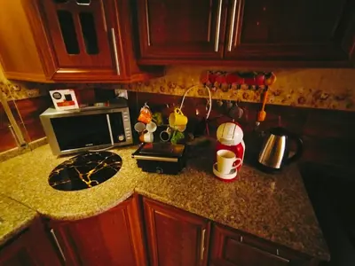 a kitchen counter with a microwave and a coffee maker at Maria Home in Madaba