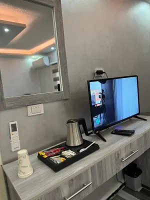 a television sitting on a shelf in a room at Petra Pillars Way Hostel in Wadi Musa