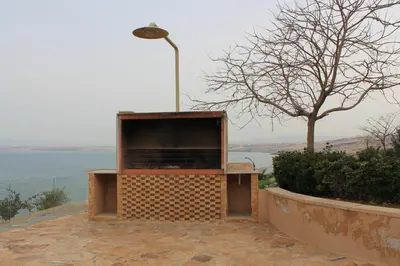 a large brick monument with a street light and a tree at Samarah Dead Sea Resort Studio-CP6 Traveler Award 2026 Winner Thursday, Friday and Saturday Groups consisting solely of male guests are not permitted in Sowayma