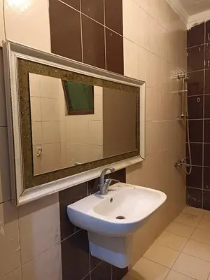 a bathroom with a sink and a mirror at Economic Apartment in Az Zarqa