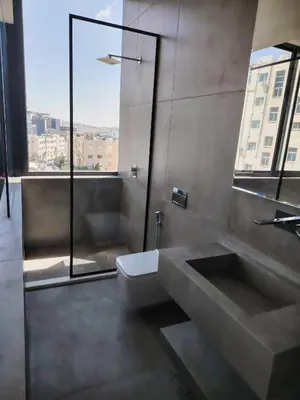 a bathroom with a toilet and a sink and a window at Rooftop one room غرفه نوم فقط in Amman