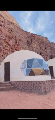 a building in the middle of a desert at Wadi rum Bubble Camp & tour in Wadi Rum