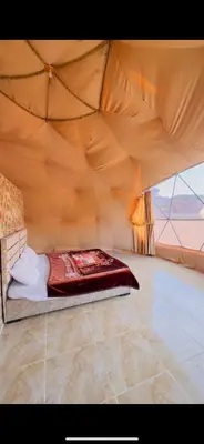 a bedroom with a bed in a tent at Wadi rum Bubble Camp & tour in Wadi Rum