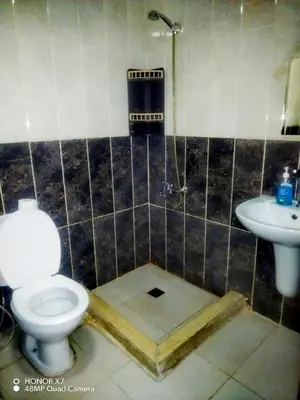 a bathroom with a toilet and a sink at Farah Plaza Hostel &Hotel Apartments in Aqaba