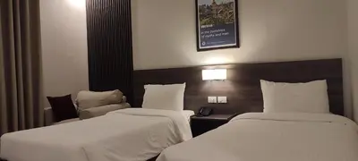 a hotel room with two beds and a telephone at Black Iris Hotel II in Madaba