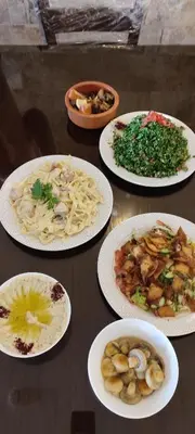 a group of plates of food on a table at Black Iris Hotel II in Madaba