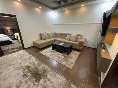 a living room with a couch and a table at Oqdeh studio in Jerash