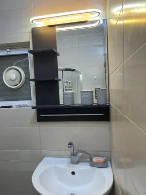 a bathroom with a sink and a mirror at Oqdeh studio in Jerash