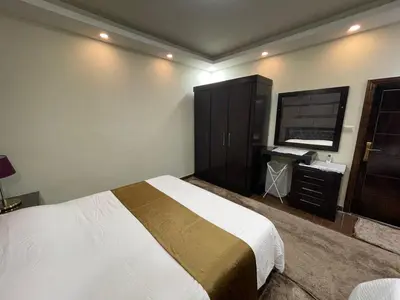 a bedroom with a bed and a flat screen tv at Oqdeh studio in Jerash