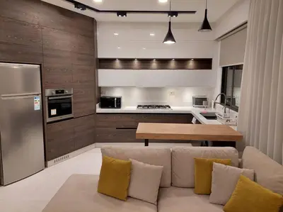 a living room with a couch and a kitchen at Exquisite Modern 2-bedroom Rental Unit in Amman