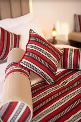 a bed with two pillows on top of it at Mountain Magic Camp Wadi Rum in Wadi Rum
