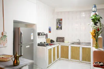 a kitchen with a refrigerator and a sink at Petra NefNaf Hostel in Wadi Musa