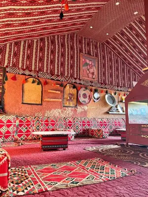 a living room with a couch and a table at Wadi Rum Trip Bedouin Camp in Wadi Rum