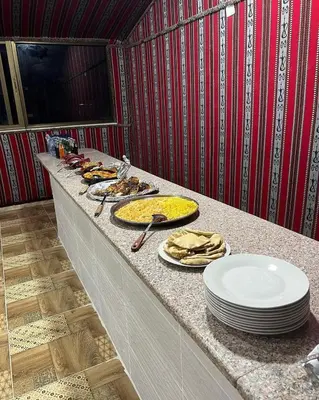 a counter with plates of food on top of it at stars magic camp in Wadi Rum