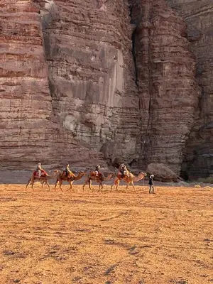 a group of people riding camels in the desert at stars magic camp in Wadi Rum