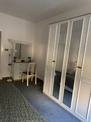 a bedroom with a bed and a dresser and a mirror at Abdoun ground floor apartment in Amman
