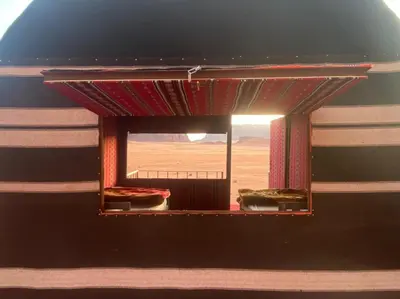 a window in a room with a view of the desert at Wadi Rum Odyssey Camp in Wadi Rum