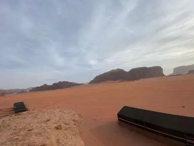 a bench sitting in the middle of the desert at Wadi Rum Odyssey Camp in Wadi Rum