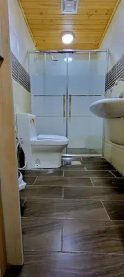 a bathroom with a toilet and a sink at atoom lodge in Jerash