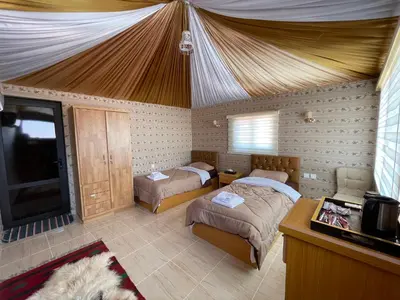 a bedroom with two beds and a tent at Rum Magic Nights in Wadi Rum