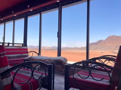 a room with chairs and a view of the desert at Rum Magic Nights in Wadi Rum