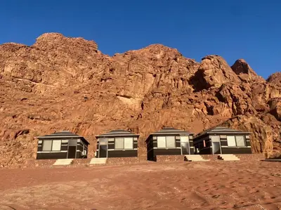 a building in front of a rocky mountain at Rum Magic Nights in Wadi Rum