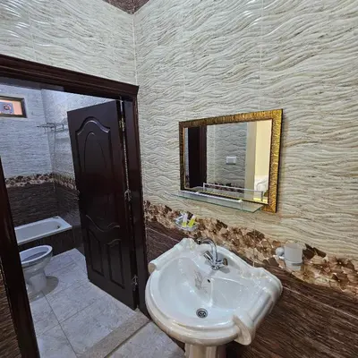 a bathroom with a sink and a toilet and a mirror at Authentic boutique in Wadi Musa