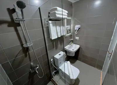 a small bathroom with a toilet and a sink at Beit Alshabaan Inn in Wadi Musa