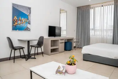 a hotel room with a bed and a television at Liv Weibdeh Hotel Suites in Amman