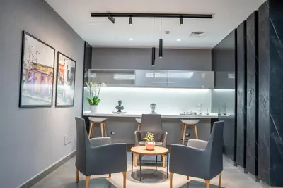 a kitchen and dining room with a table and chairs at Liv Weibdeh Hotel Suites in Amman
