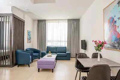a waiting room with blue chairs and a table at Liv Weibdeh Hotel Suites in Amman