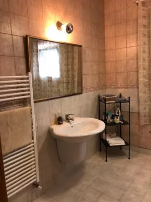 a bathroom with a sink and a mirror at Charming House in Amman + Balcony in Amman
