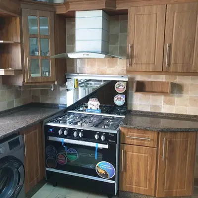 a kitchen with a stove top oven in a kitchen at شقة مفروشة في ام اذينة in Amman