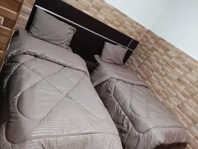 a large bed in a brick room at Dead sea 2 bedroom apartment in Astana ,swemeh Jordan in Sowayma