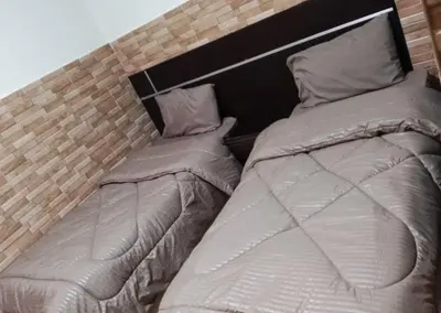 two beds sitting next to each other in a bedroom at Dead sea 2 bedroom apartment in Astana ,swemeh Jordan in Sowayma