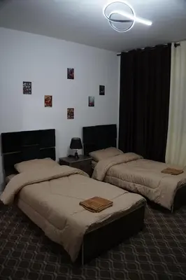 a bedroom with two beds and a ceiling at Petra voyager Hostel in Wadi Musa