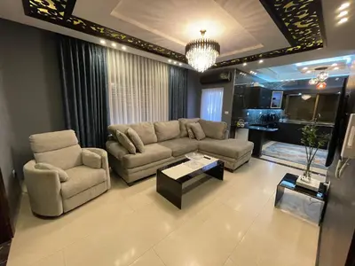 a living room with a couch and a table at Alghalayieny Modern Apartments in Amman