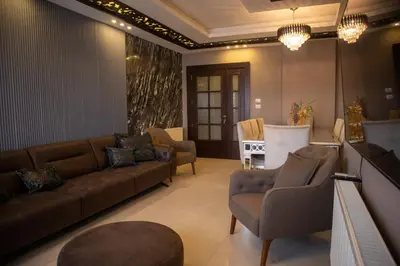 a living room with a couch and chairs at Alghalayieny Modern Apartments in Amman