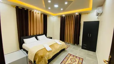 a bedroom with a bed with white pillows at Petra Olive House in Wadi Musa
