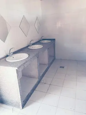a bathroom with three sinks in a room at Wadi Rum Local Guide in Wadi Rum